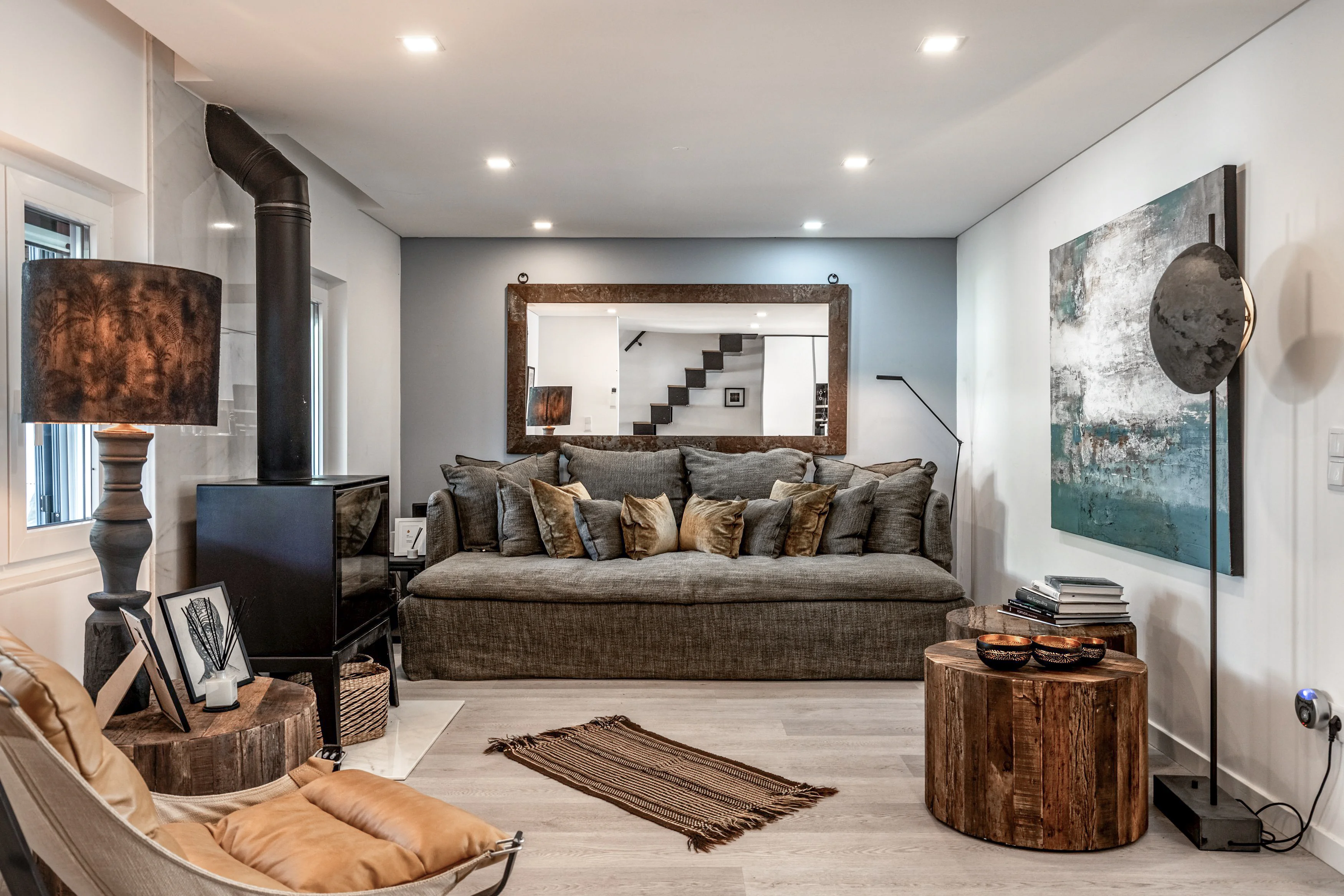 Living room with wood-burning stove and leather chaise at Comporta Village House